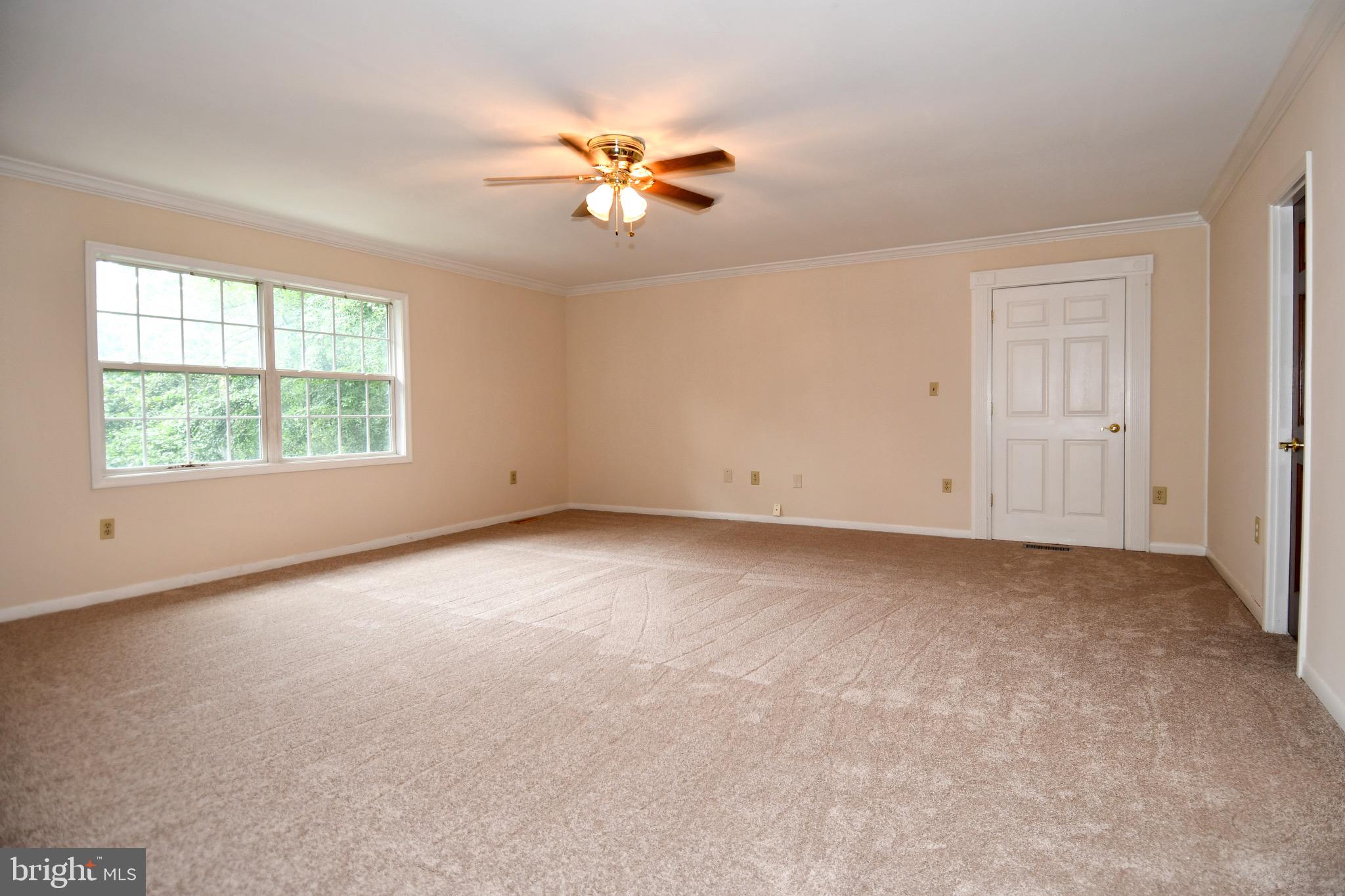3203 Riverview Drive Triangle, VA 22172 - Photo 23 of 78 an empty room with windows and chandelier fan