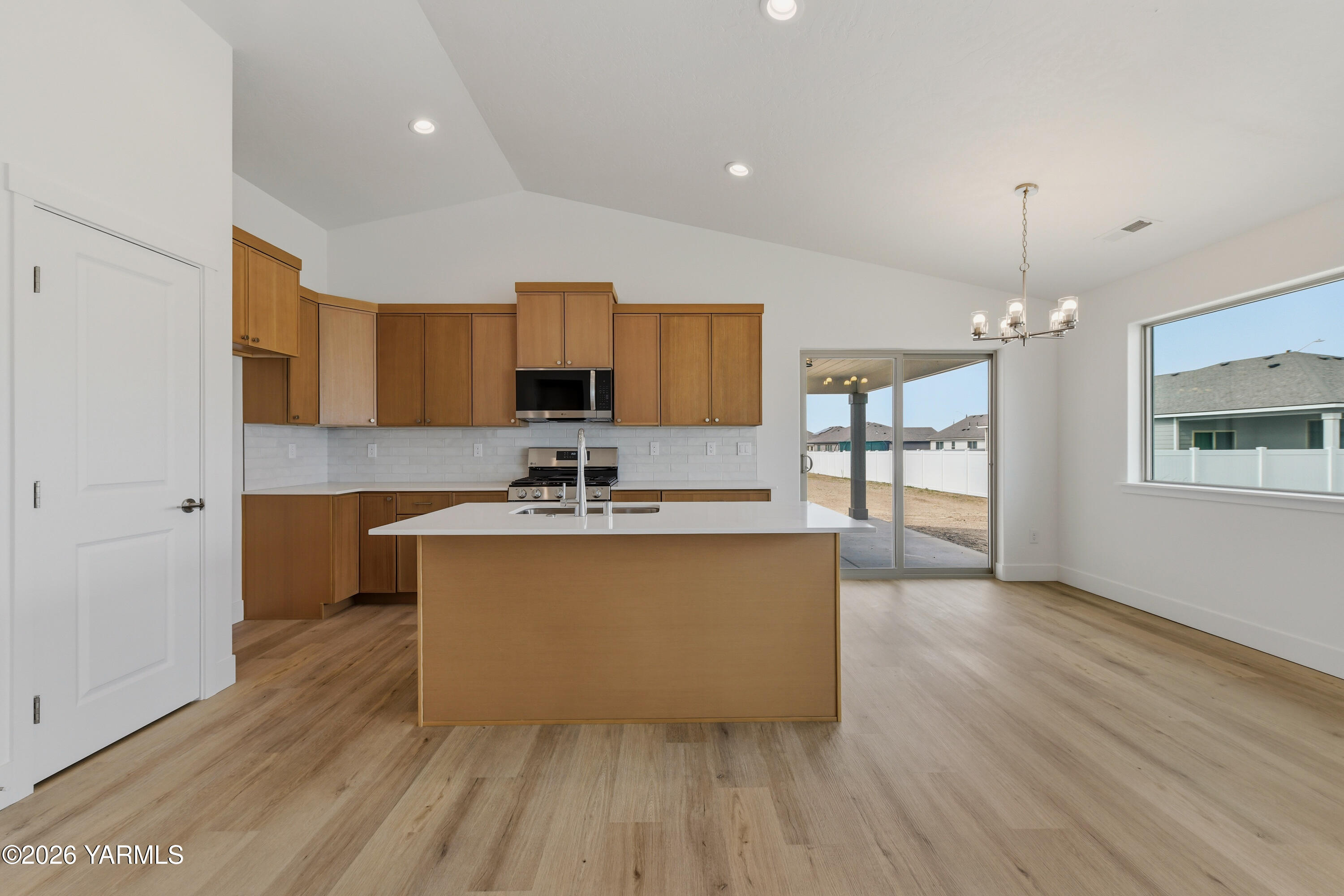 606 Grapevine Street, Unit PHASE 3 LOT 8) SPEC Grandview, WA 98930 - Photo 11 of 28 a kitchen with stainless steel appliances granite countertop a sink cabinets and wooden floor