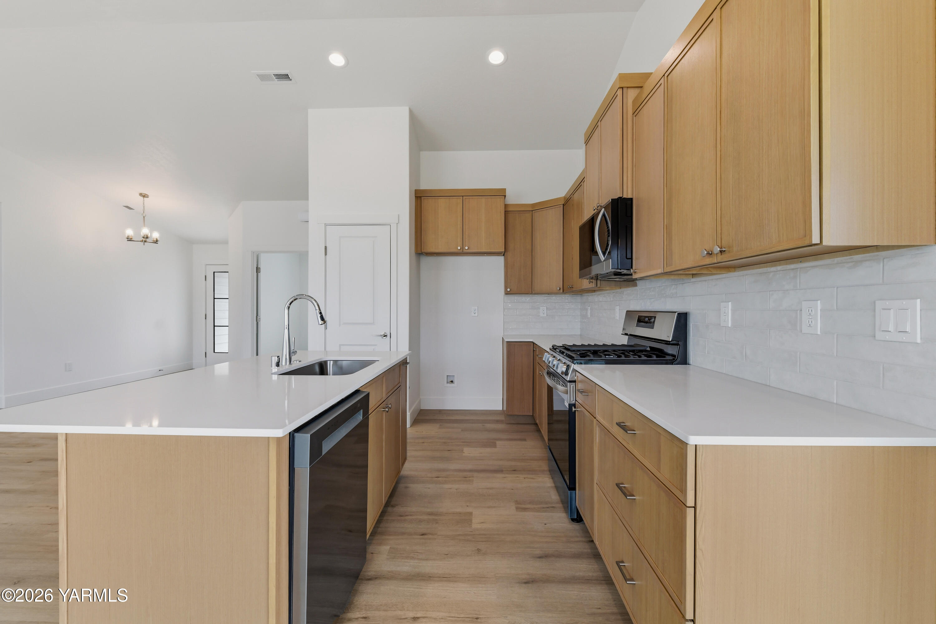 606 Grapevine Street, Unit PHASE 3 LOT 8) SPEC Grandview, WA 98930 - Photo 13 of 28 a kitchen with stainless steel appliances granite countertop a sink a stove and a refrigerator