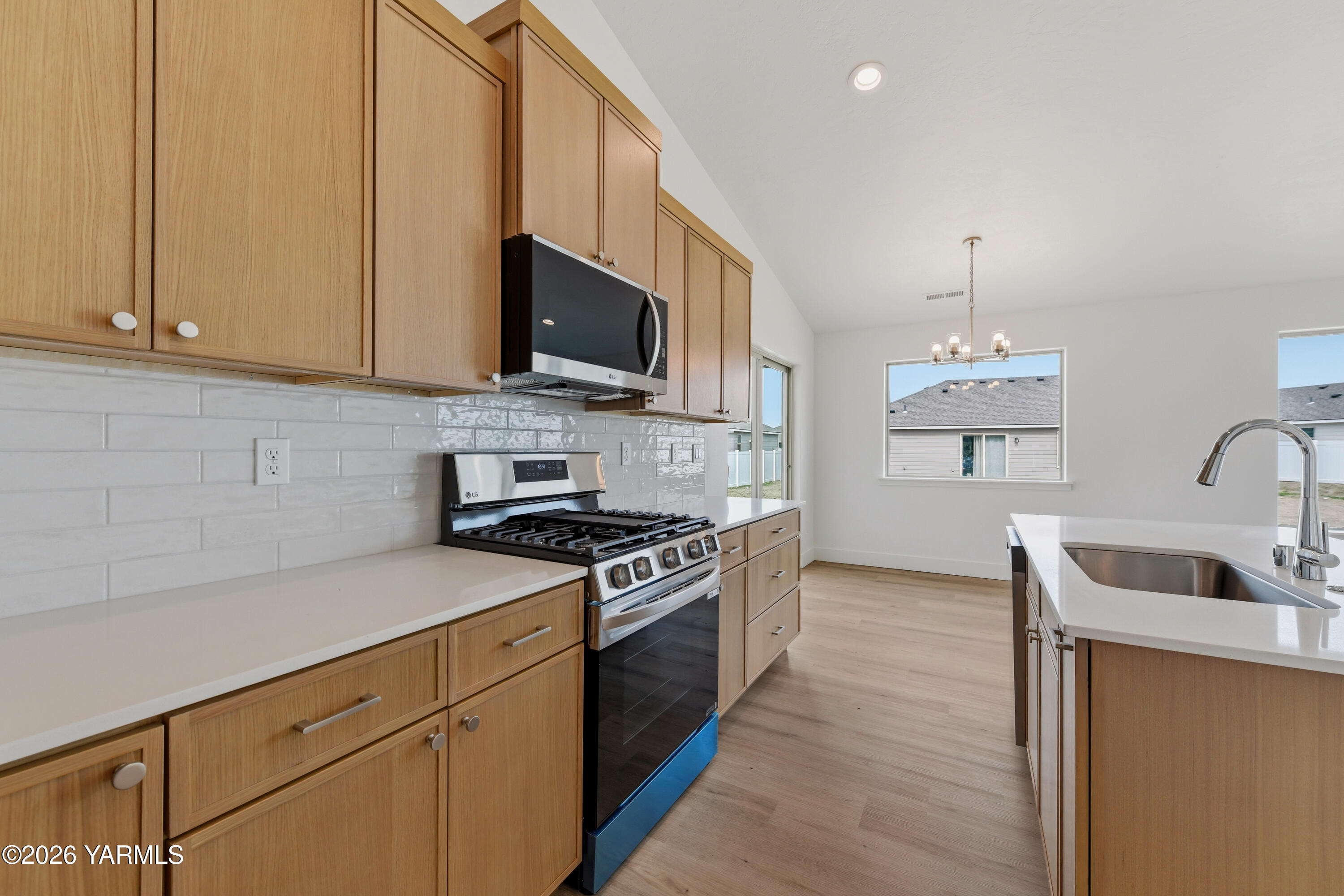 606 Grapevine Street, Unit PHASE 3 LOT 8) SPEC Grandview, WA 98930 - Photo 14 of 28 a kitchen with stainless steel appliances granite countertop a sink a stove and a refrigerator
