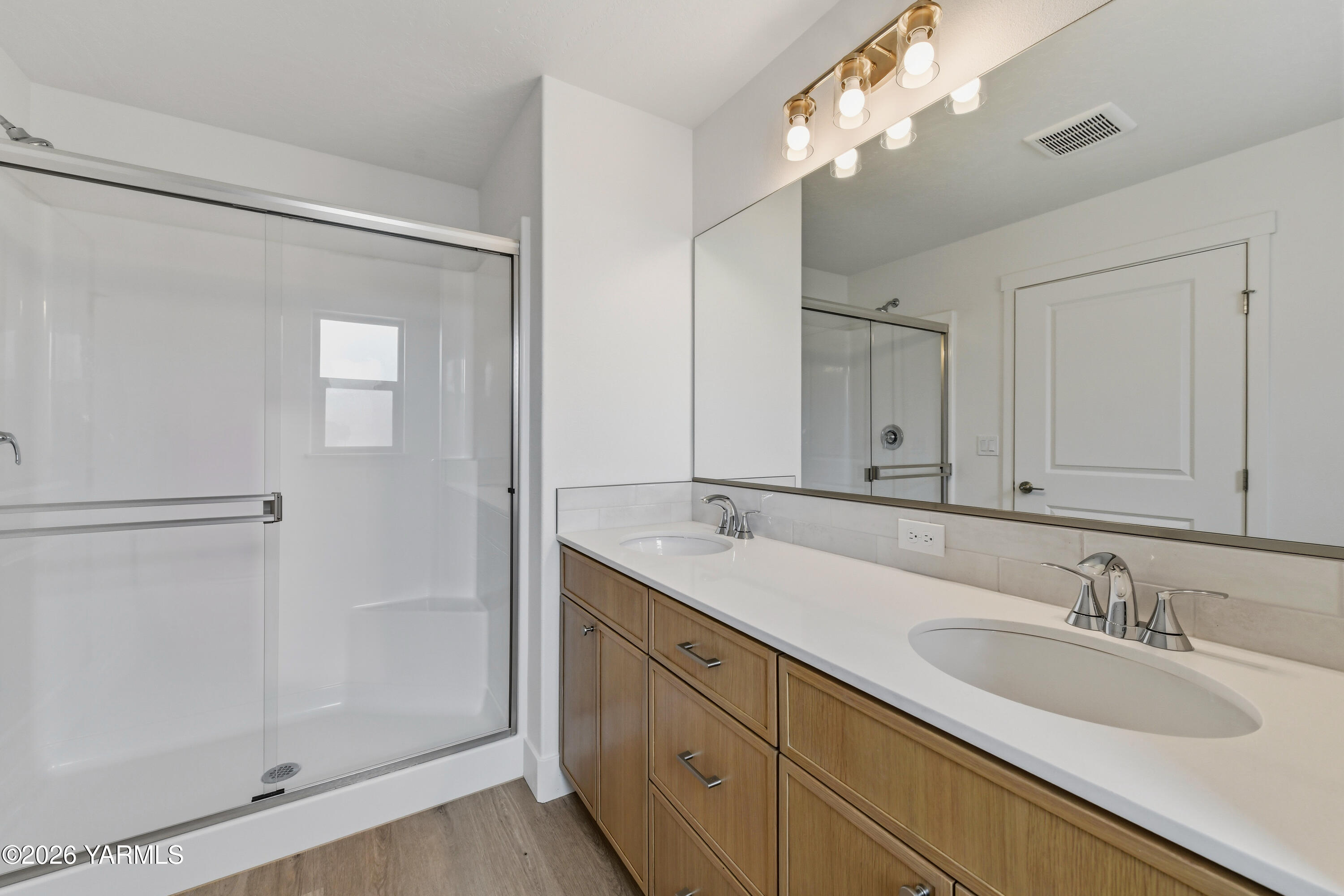 606 Grapevine Street, Unit PHASE 3 LOT 8) SPEC Grandview, WA 98930 - Photo 23 of 28 a bathroom with a double vanity sink and a mirror