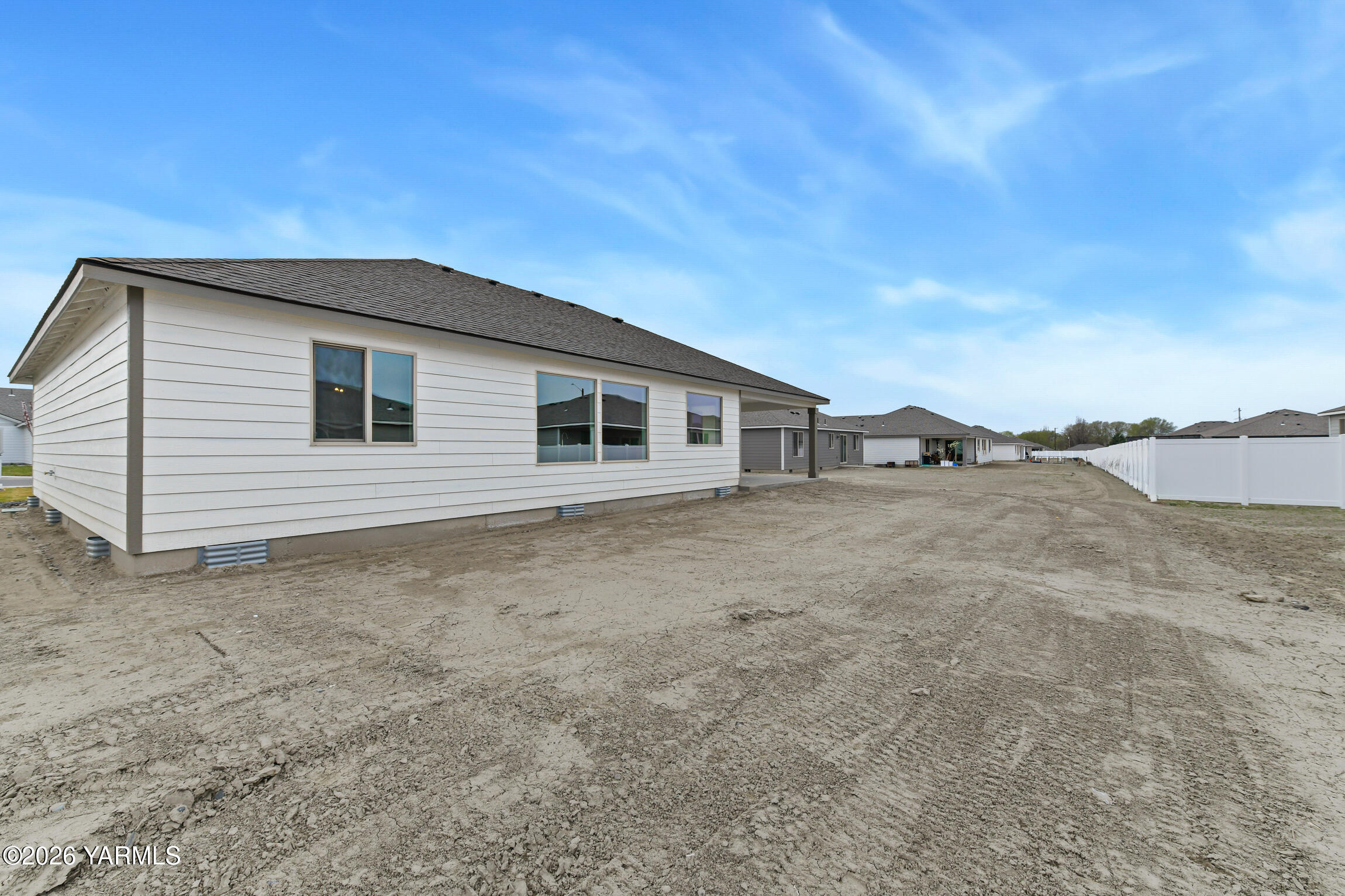 606 Grapevine Street, Unit PHASE 3 LOT 8) SPEC Grandview, WA 98930 - Photo 25 of 28 a view of a house with a backyard