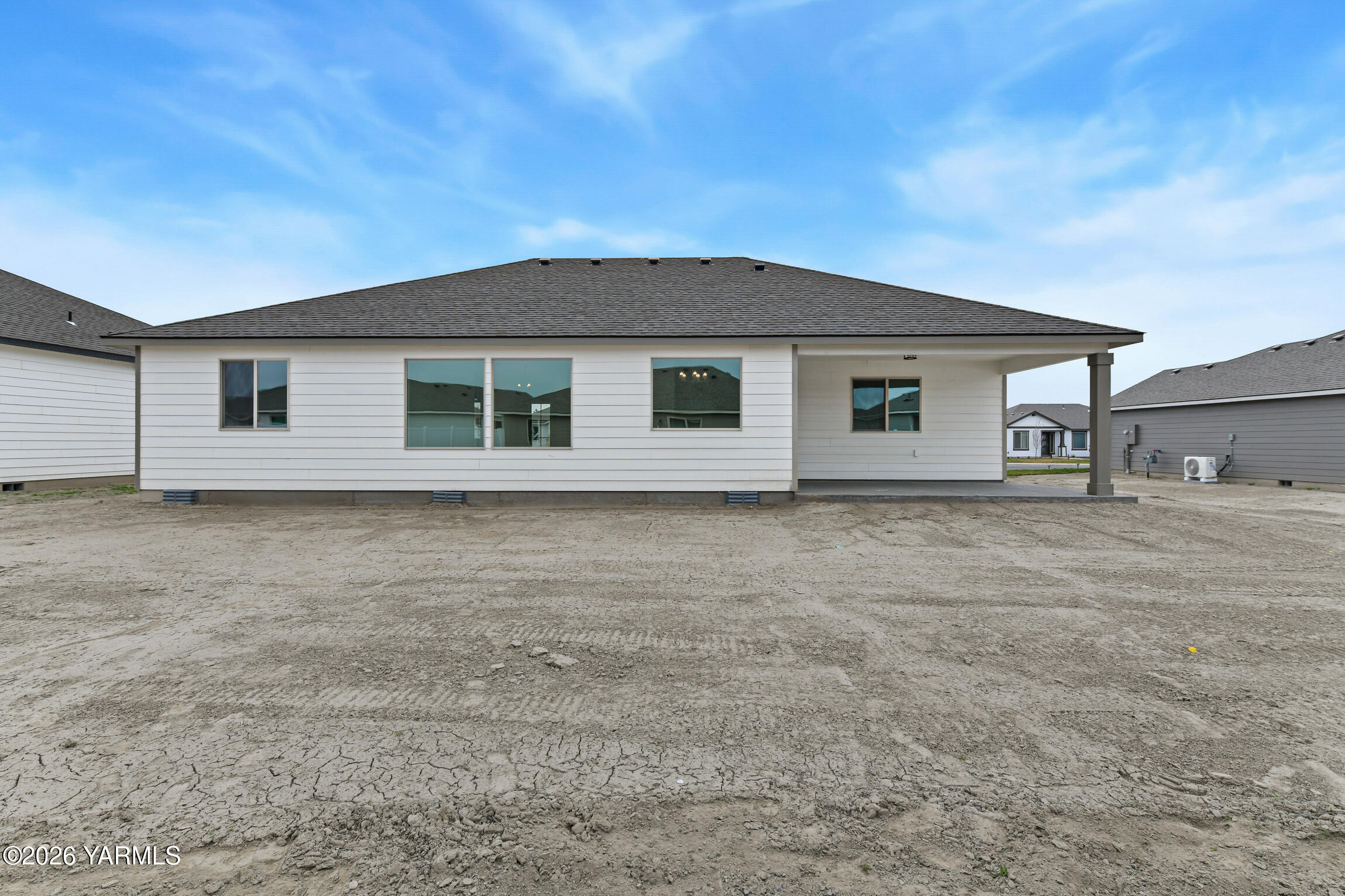 606 Grapevine Street, Unit PHASE 3 LOT 8) SPEC Grandview, WA 98930 - Photo 26 of 28 a front view of a house with a garden