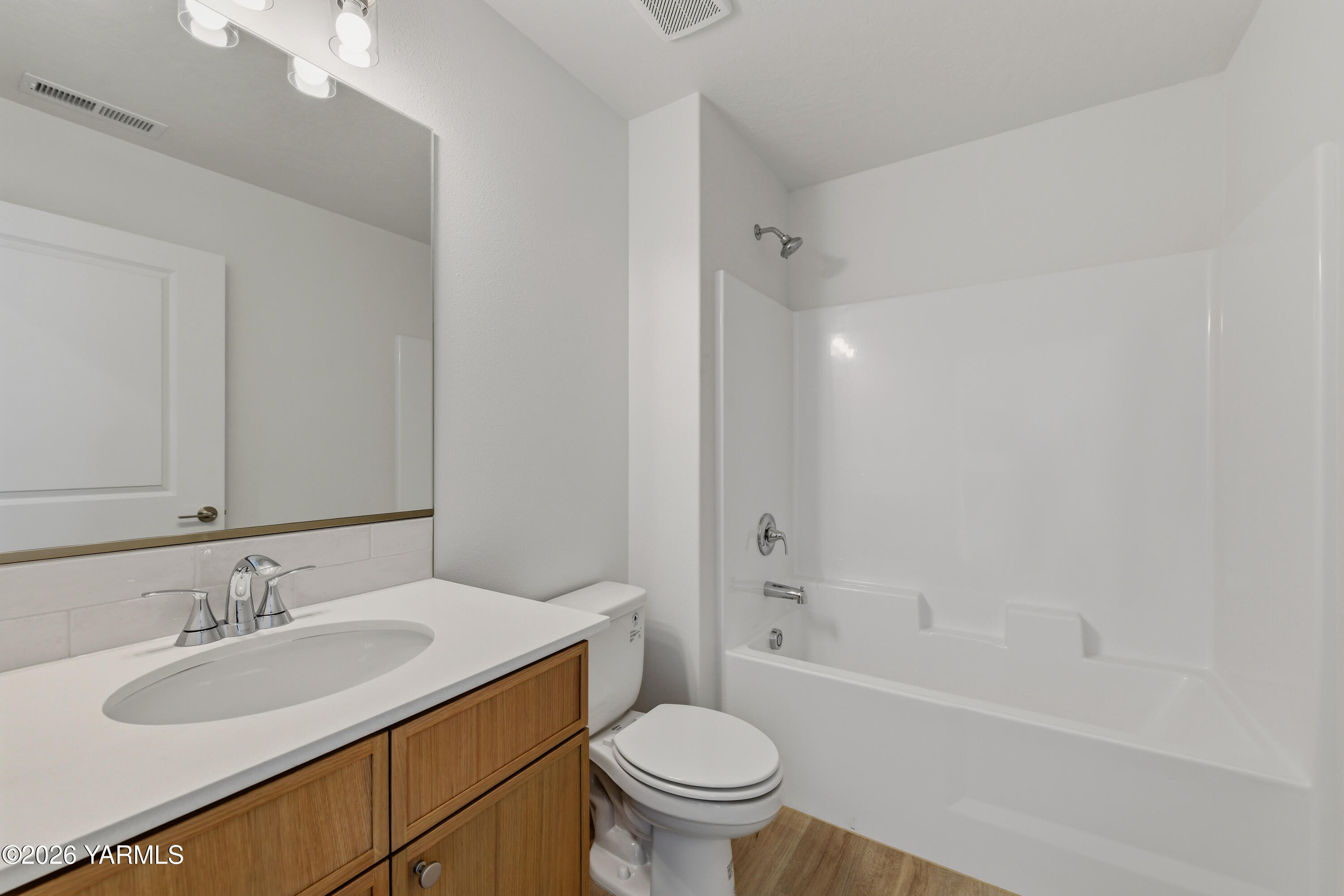 606 Grapevine Street, Unit PHASE 3 LOT 8) SPEC Grandview, WA 98930 - Photo 7 of 28 a bathroom with a sink toilet vanity and shower