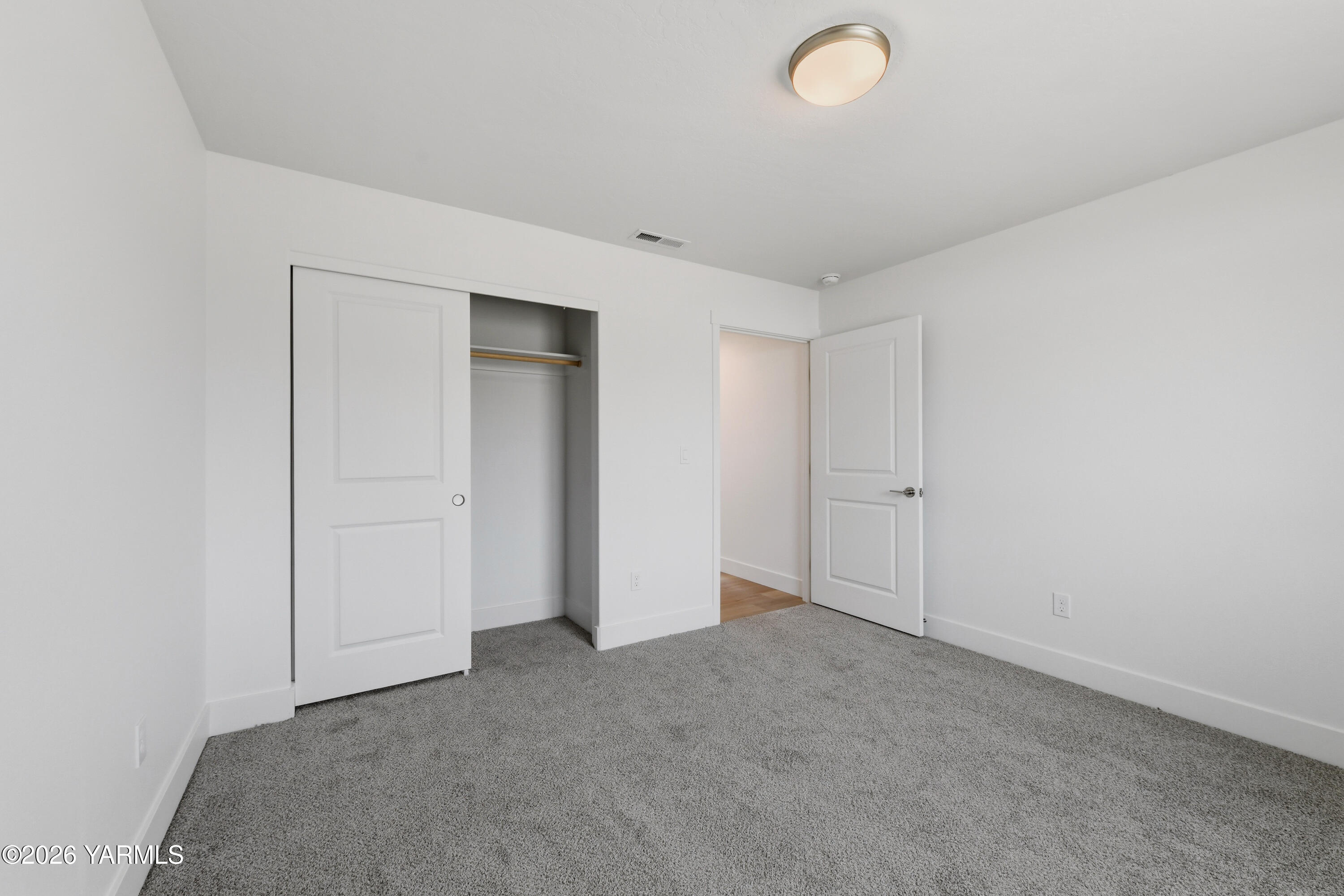 606 Grapevine Street, Unit PHASE 3 LOT 8) SPEC Grandview, WA 98930 - Photo 9 of 28 an empty room with closet area