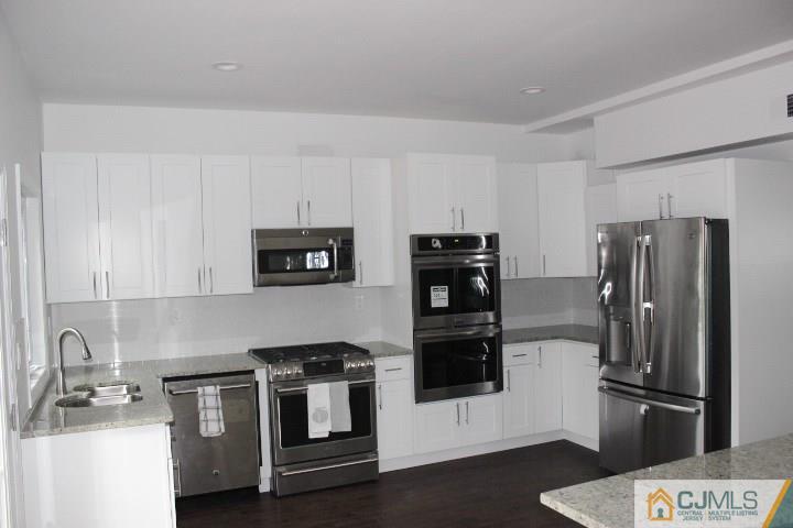 15 Sturgis Road Edison, NJ 08817 - Photo 40 of 50 a kitchen with stainless steel appliances and cabinets