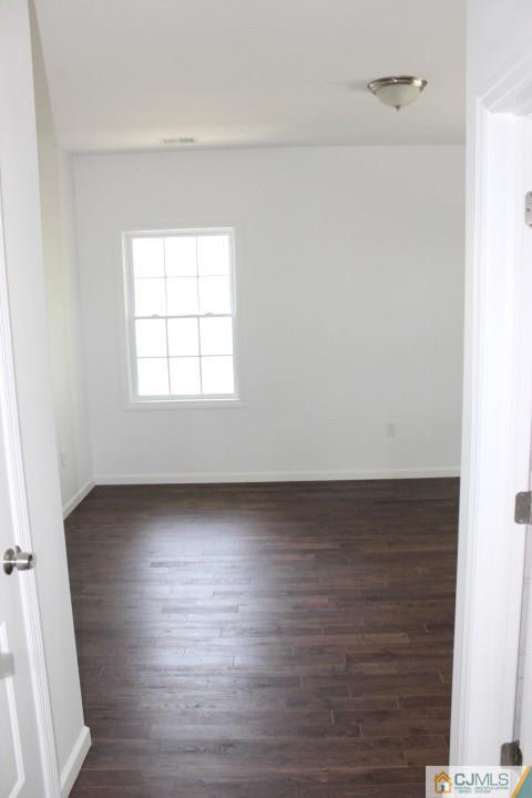 15 Sturgis Road Edison, NJ 08817 - Photo 8 of 50 an empty room with wooden floor and windows