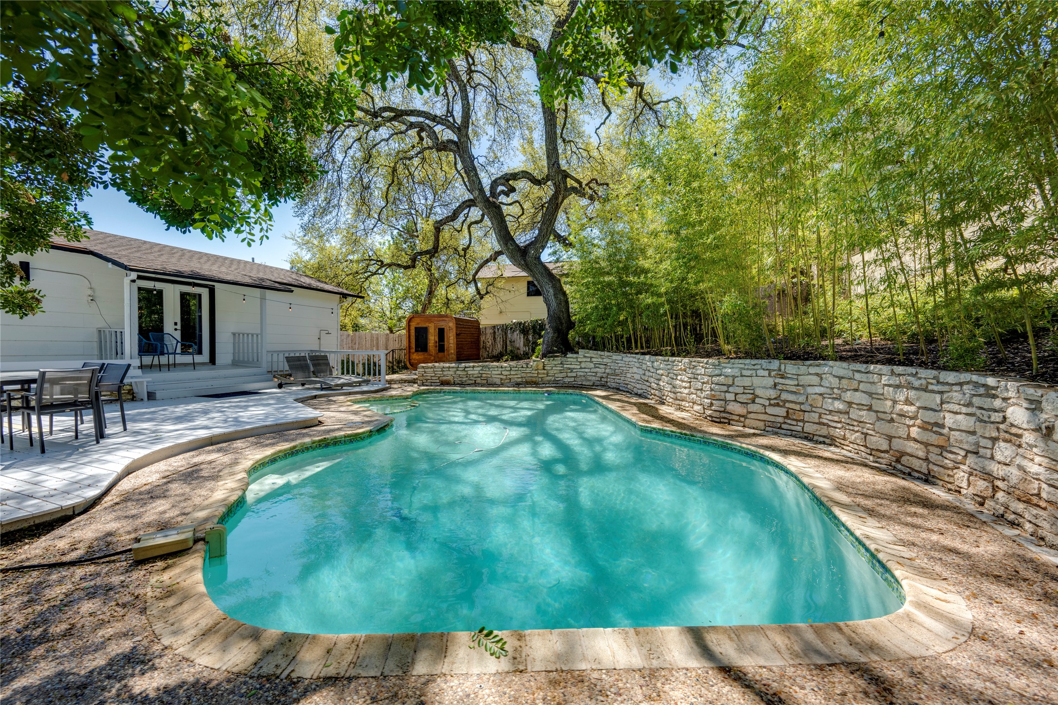 Swimming pool with french doors, a patio area, a fenced backyard, and outdoor dining area