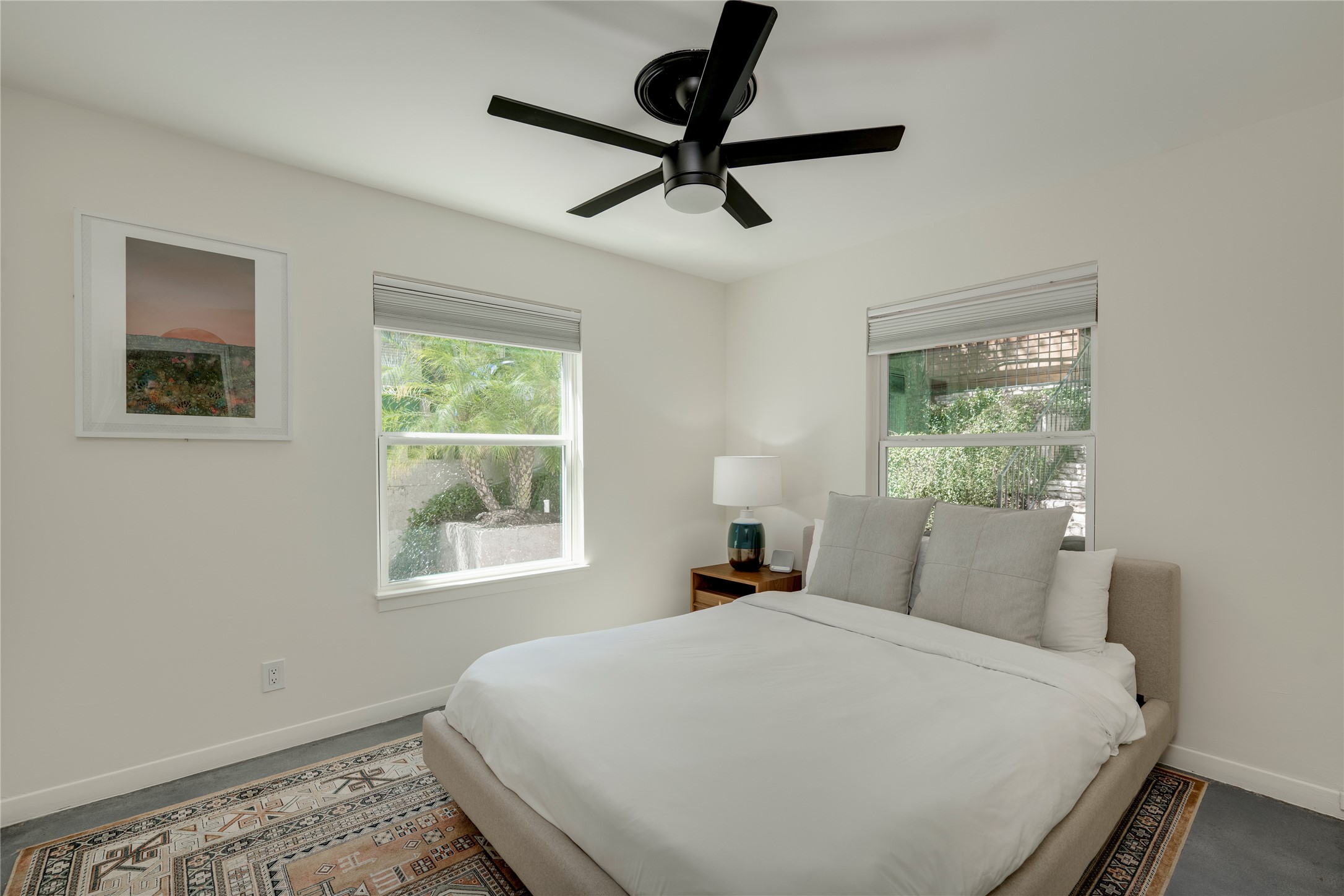3606 Wilson Street Austin, TX 78704 - Photo 15 of 34 Bedroom featuring a ceiling fan and concrete flooring