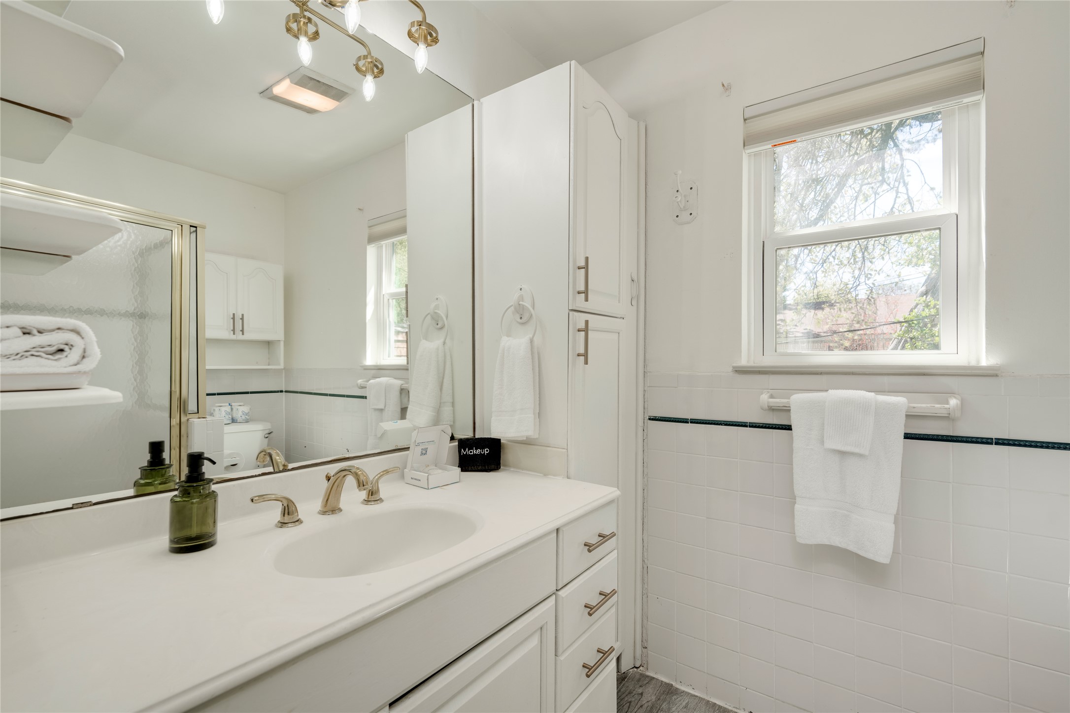 3606 Wilson Street Austin, TX 78704 - Photo 17 of 34 Bathroom featuring vanity, tile walls, and a wainscoted wall