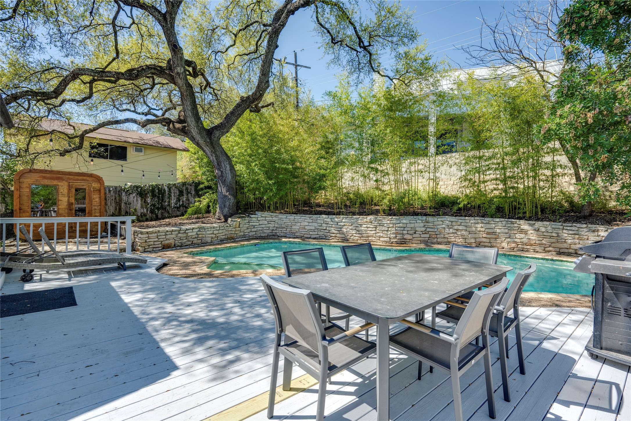 3606 Wilson Street Austin, TX 78704 - Photo 28 of 34 Wooden terrace featuring a grill, a fenced backyard, and outdoor dining area