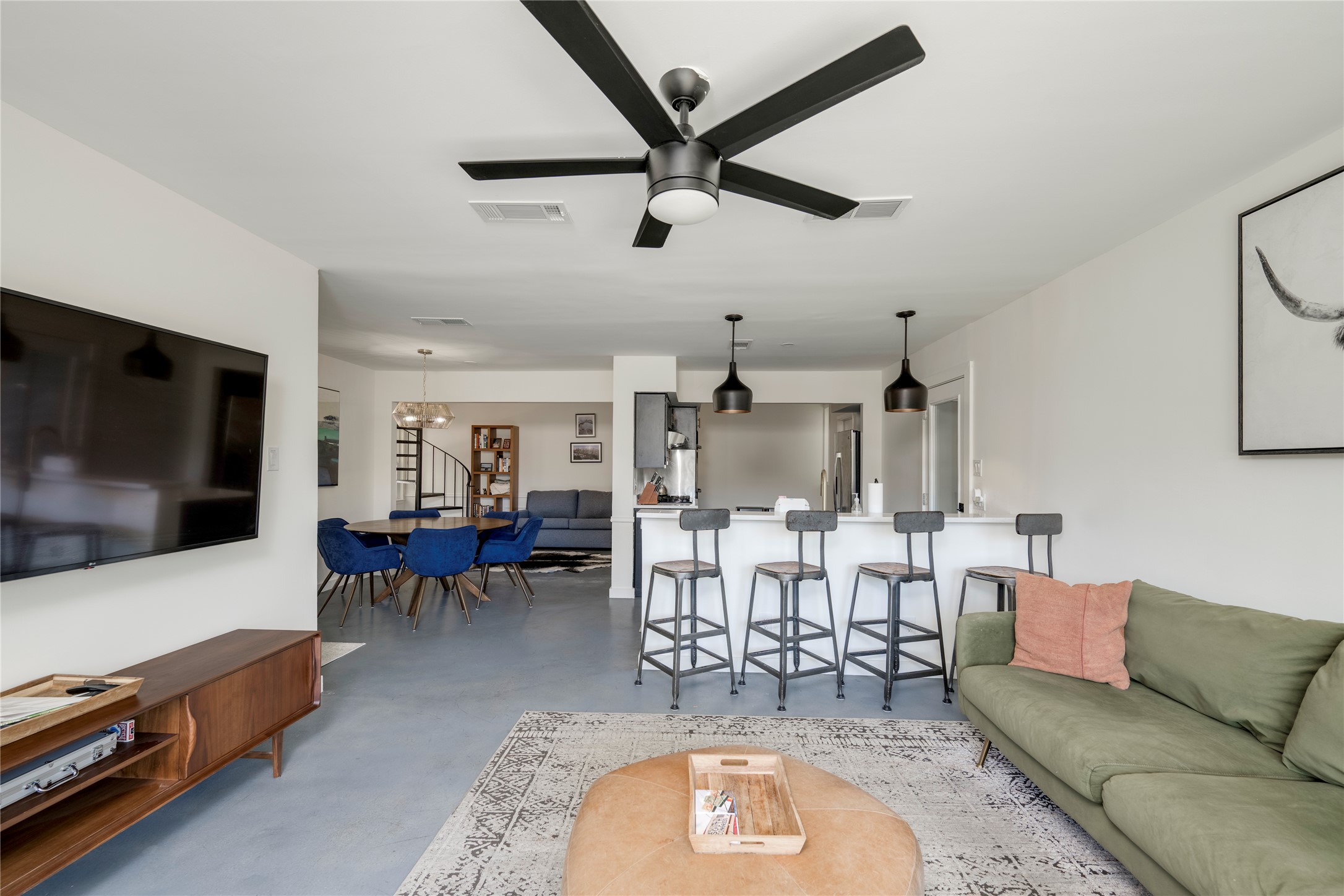 3606 Wilson Street Austin, TX 78704 - Photo 4 of 34 Living area featuring concrete floors, a ceiling fan, and a chandelier