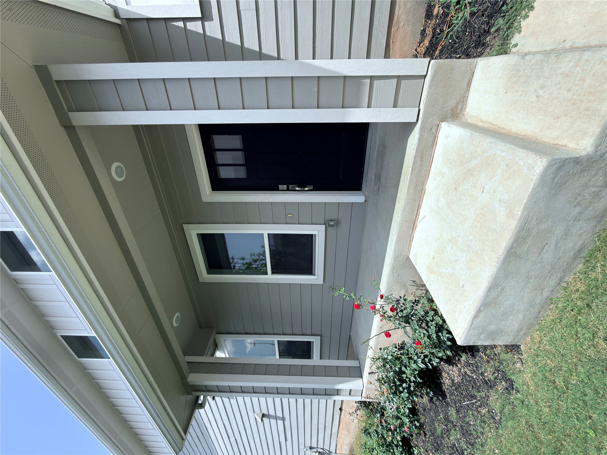11216 Gadsen Lane Austin, TX 78754 - Photo 5 of 36 A welcoming front entry with modern gray siding and a dark contrast door awaits.
