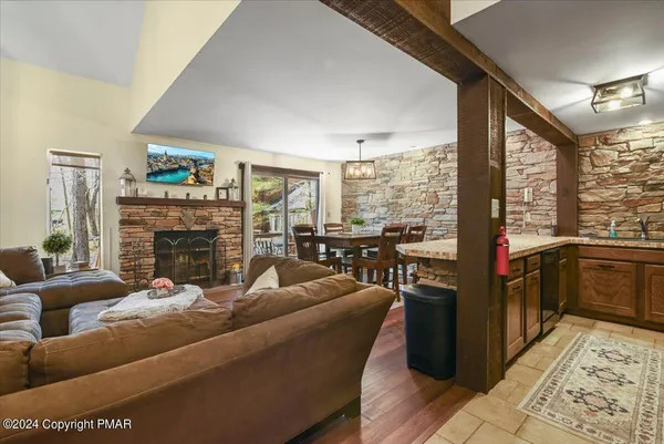 a living room with fireplace furniture and a large window