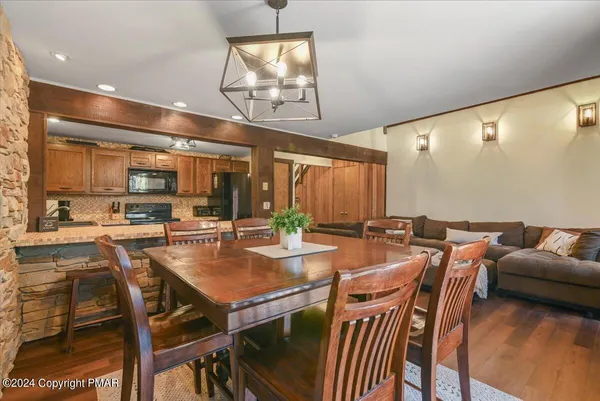 a view of a dining room with furniture and wooden floor