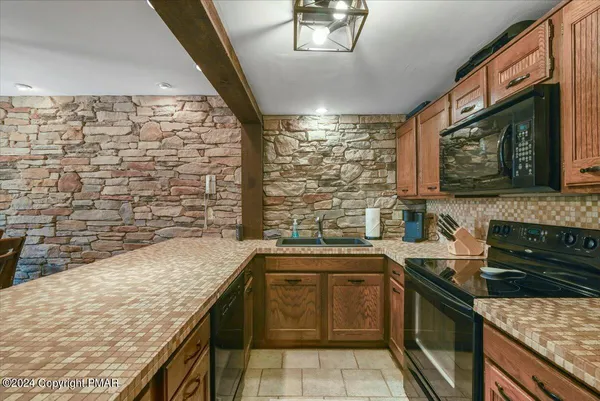 a kitchen with stainless steel appliances granite countertop a sink stove and oven