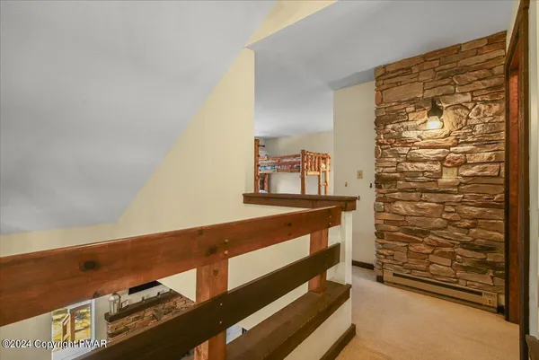 a view of an empty room and wooden floor