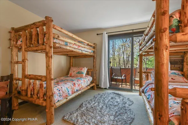 a bedroom with a bed and large window