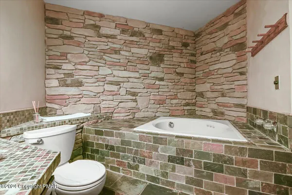 a bathroom with a toilet a sink and shower