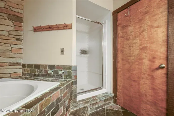 a bathroom with a bathtub and a shower