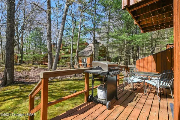 a view of balcony with wooden floor and outdoor seating