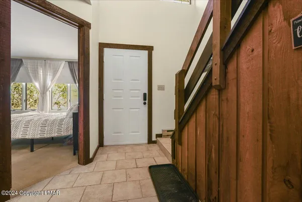 a view of entryway with bedroom and window
