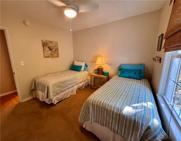 a bedroom with two beds and painting on the wall