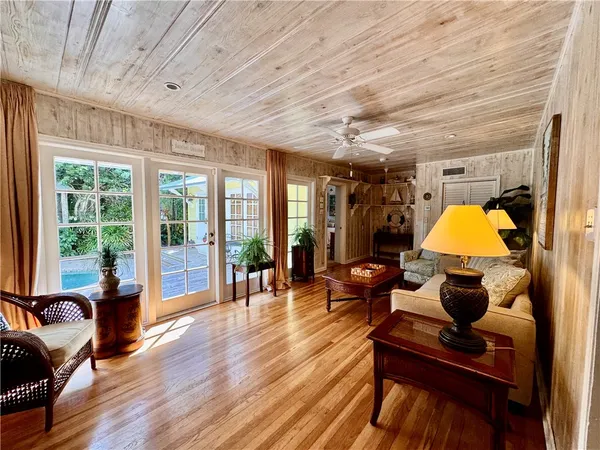 a living room filled with furniture and a wooden floor
