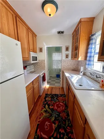 a kitchen with sink a stove and refrigerator
