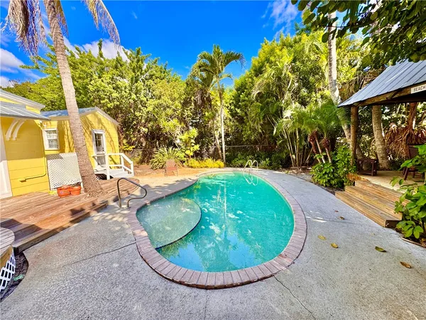 a view of a swimming pool with an outdoor seating