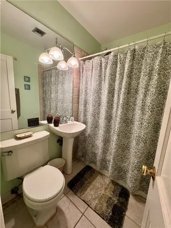 a bathroom with a sink toilet and a mirror