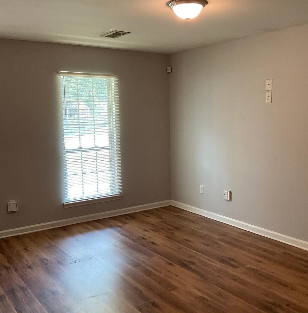1521 Hope Street Memphis, TN 38111 - Photo 2 of 9 an empty room with wooden floor and windows