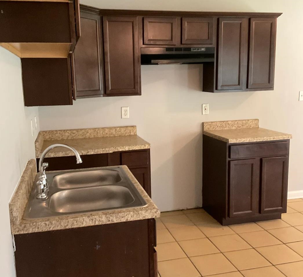 1521 Hope Street Memphis, TN 38111 - Photo 3 of 9 a kitchen with granite countertop a sink and a stove top oven