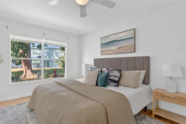 a bedroom with a large bed and a large window