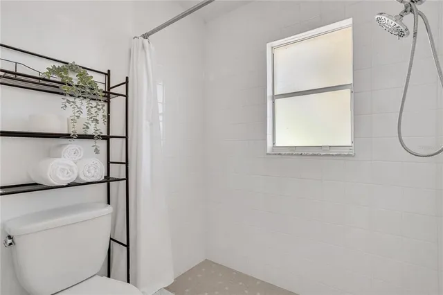 a bathroom with a shower and a window
