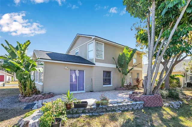 a front view of small house with yard and outdoor seating