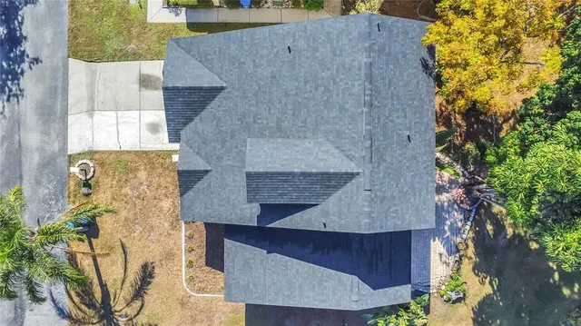 an aerial view of a house with a garden and statue