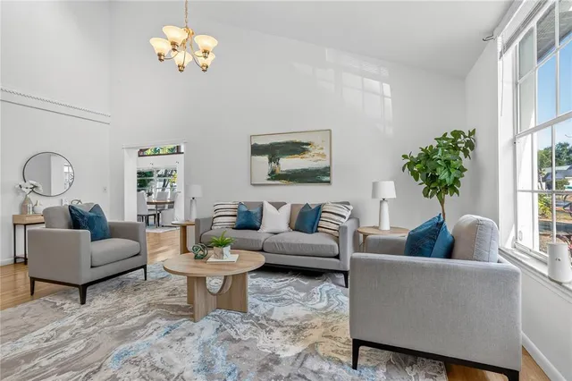 a living room with furniture a rug and a window