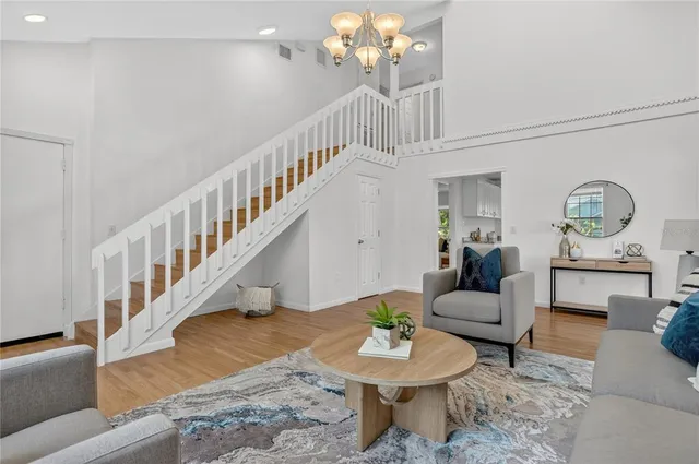 a living room with furniture and a chandelier