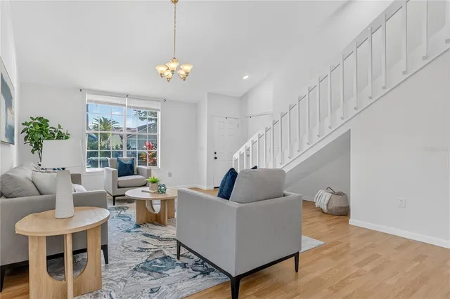a living room with furniture and a potted plant