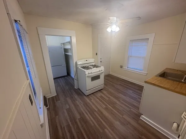 a kitchen with a sink and a stove top oven
