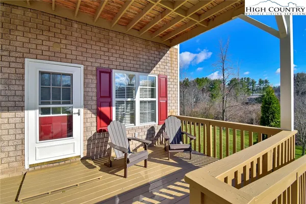 a view of a roof deck with wooden floor and fence