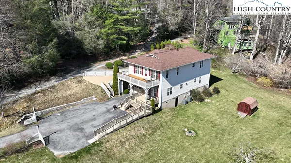 an aerial view of a house with yard