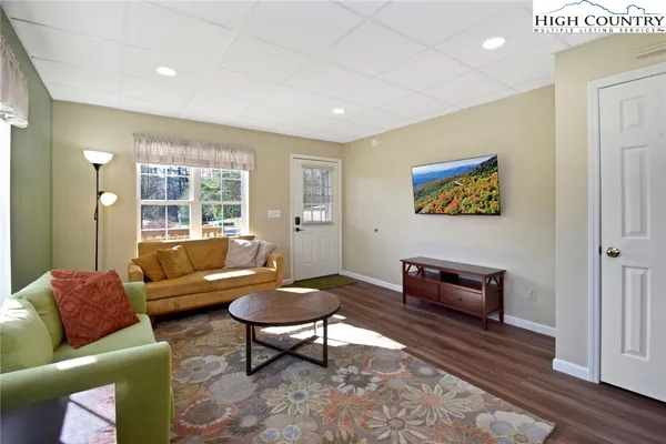 a living room with furniture a rug and a large window