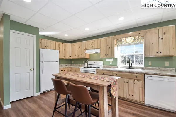 a kitchen with refrigerator a sink and cabinets