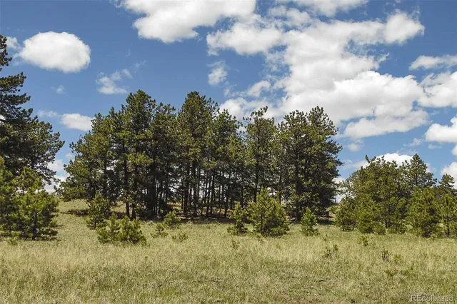 a view of mountain with sunset in background