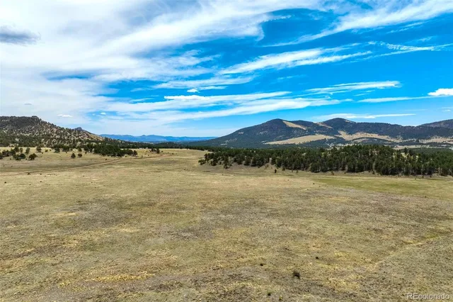 a view of a mountain with mountains in the background