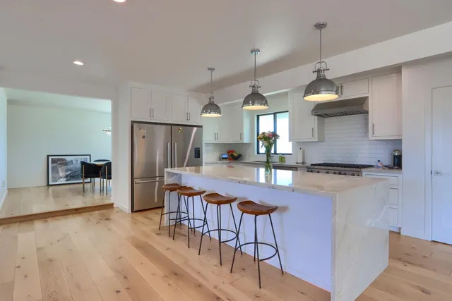 a bedroom with a large bed and a large window