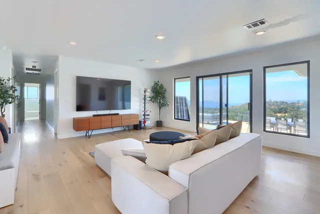 a bedroom with a large bed and a painting on the wall