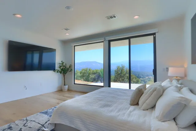 a bedroom with a large bed and a large window